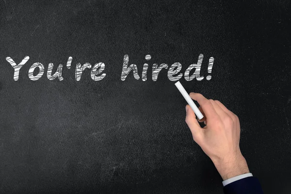 You're hired text on black board — Stock Photo, Image