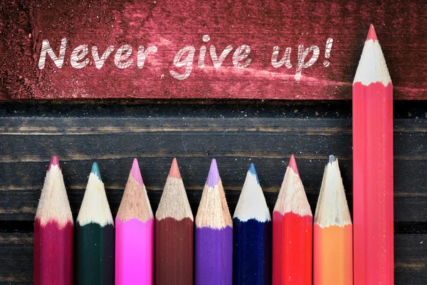 Never give up text and group of pencil on table — Stock Photo, Image