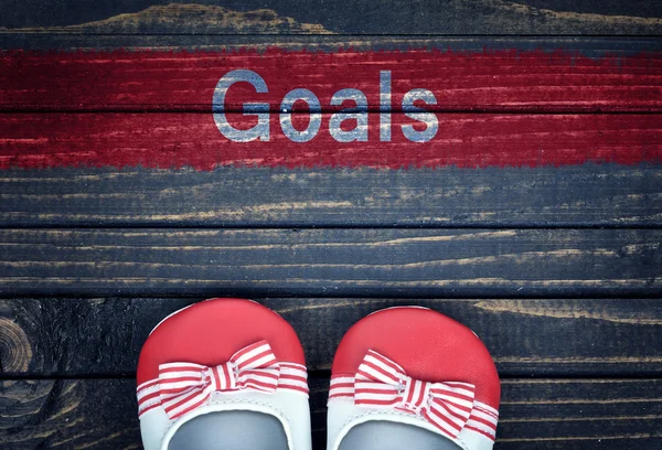 Goals message and kid shoes on floor — Stock Photo, Image