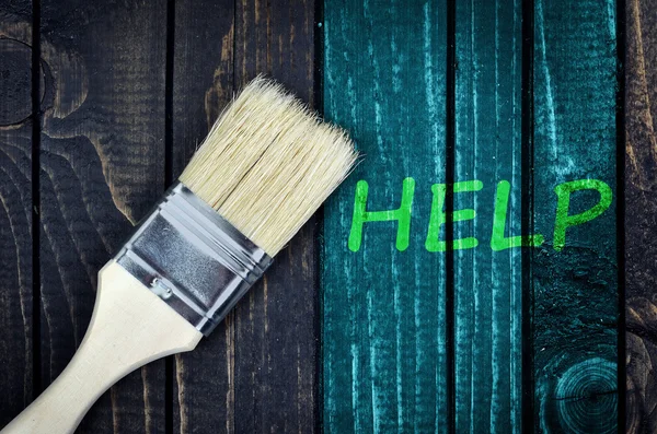 Help message and paintbrush on wall — Stock Photo, Image