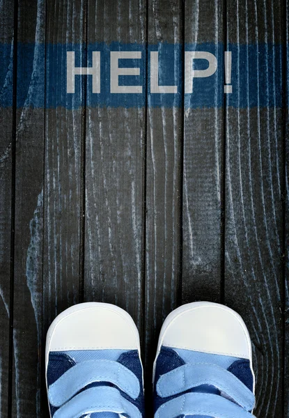 Help message and kid shoes on floor — Stock Photo, Image