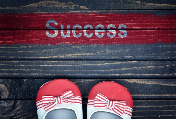 Messaggio di successo e scarpe per bambini sul pavimento — Foto Stock