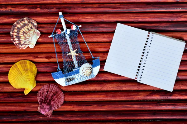 Toy ship and notepad — Stock Photo, Image
