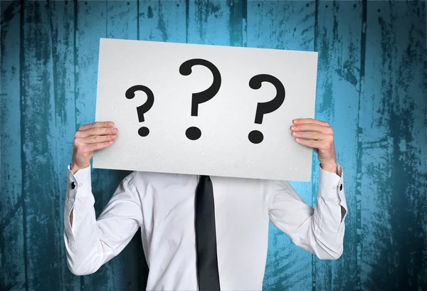 Man cover face with question board — Stock Photo, Image