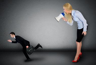 Business woman screaming on megaphone 
