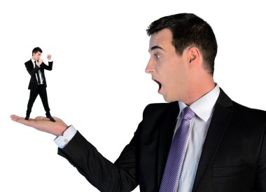 Business man looking shocked on little man