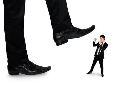 Feet man crushing little business man 