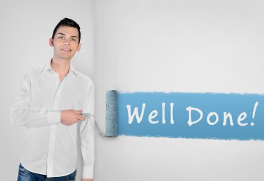 Man painting Well done word on wall