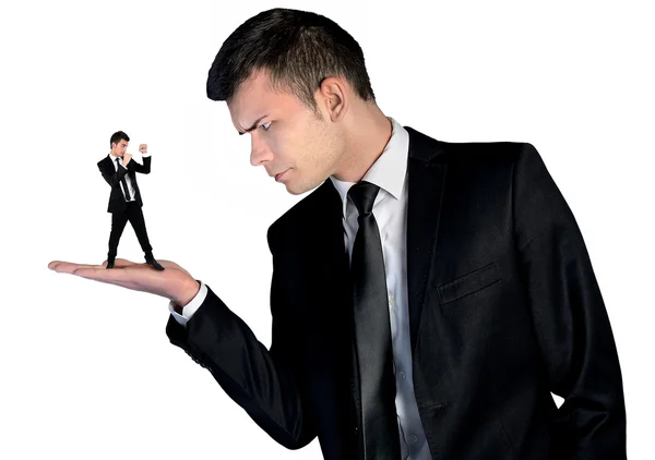 Business man looking angry on little man — Stockfoto