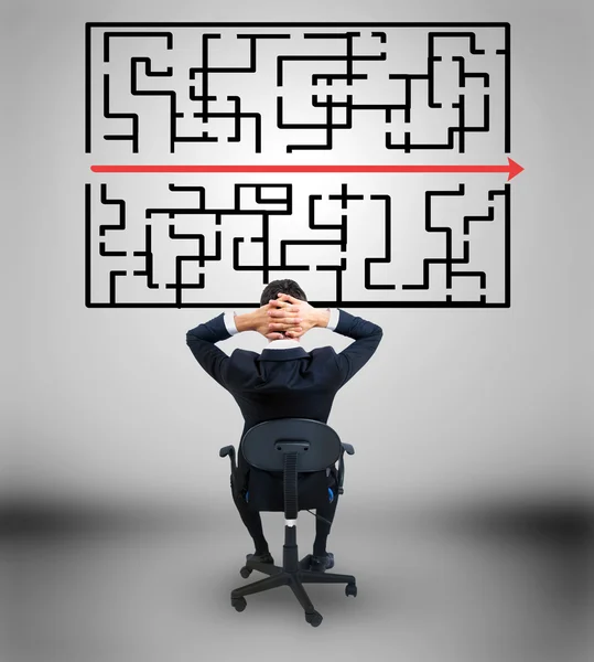 Business man looking at maze solution — Stock Photo, Image