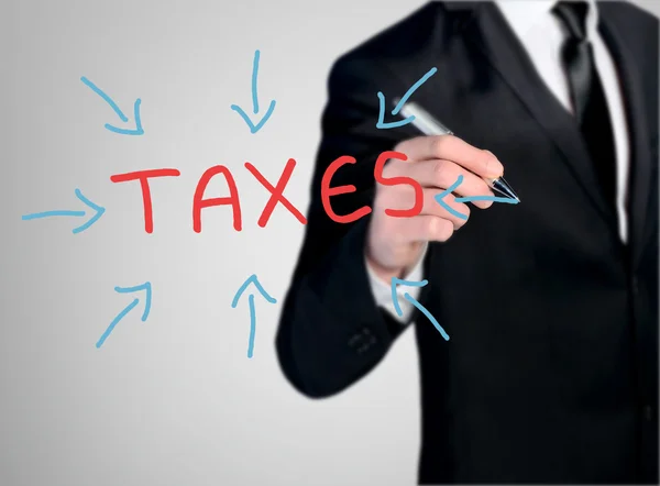 Business man write taxes word — Stock Photo, Image