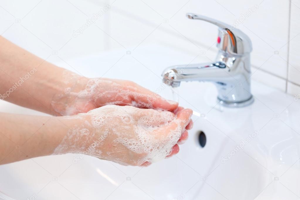 Washing of hands with soap under running water