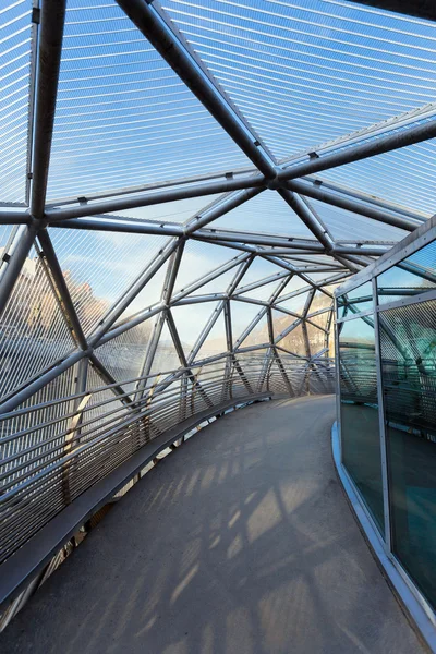 Island on Mur river connected by a modern steel and glass bridge — Stock Photo, Image