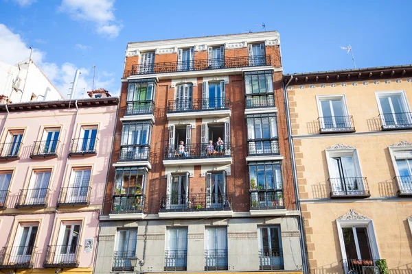 Young girls on balconies of a typical building facade on a stree — Stock Photo, Image