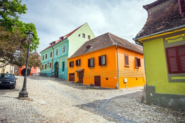 Stone paved old streets with colored houses from Sighisoara fortresss, Transylvania