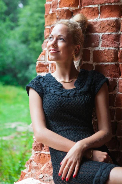 Tuğla duvar arka plan üzerinde genç kadın