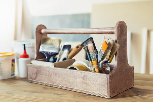 Crafting supplies in wooden toolbox — Stock Photo, Image