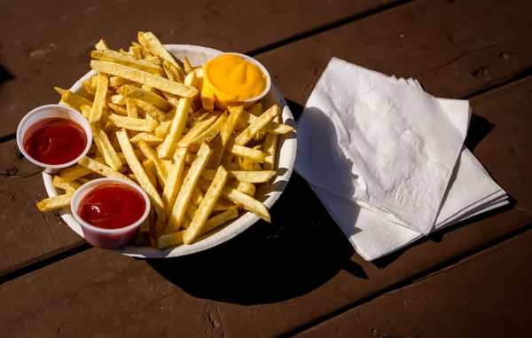 French fries with ketchup and cheese — Stock Photo, Image