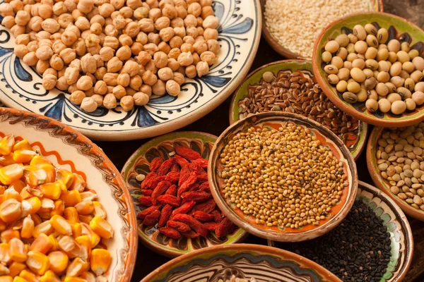 Various grain beans in small clay plates on natural textured woo — Stock Photo, Image