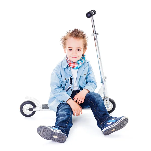 Tired small boy resting on scooter — Stock Photo, Image