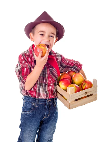 Little farmer boy tasting good apple — Stock Photo, Image