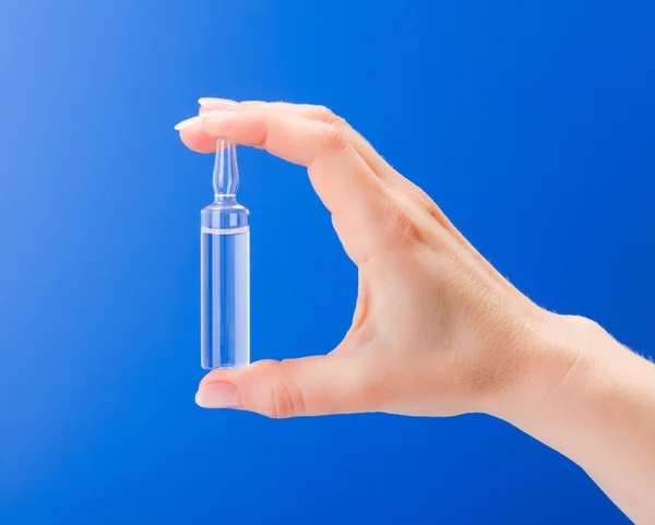 Woman's hand holding an ampoule — Stock Photo, Image