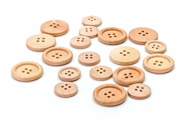Botones de madera sobre superficie blanca — Foto de Stock