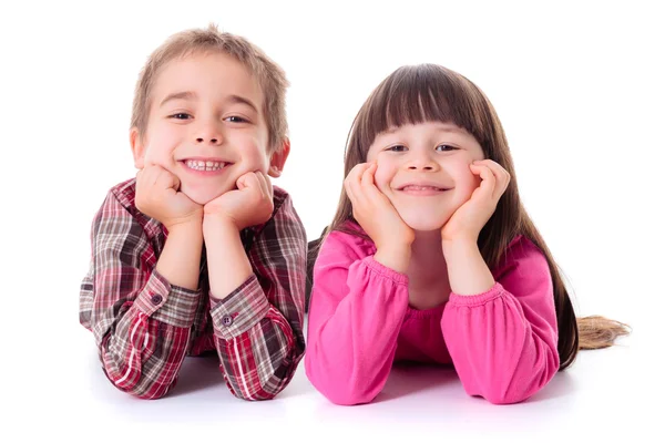 Happy children lying on white Royalty Free Stock Images