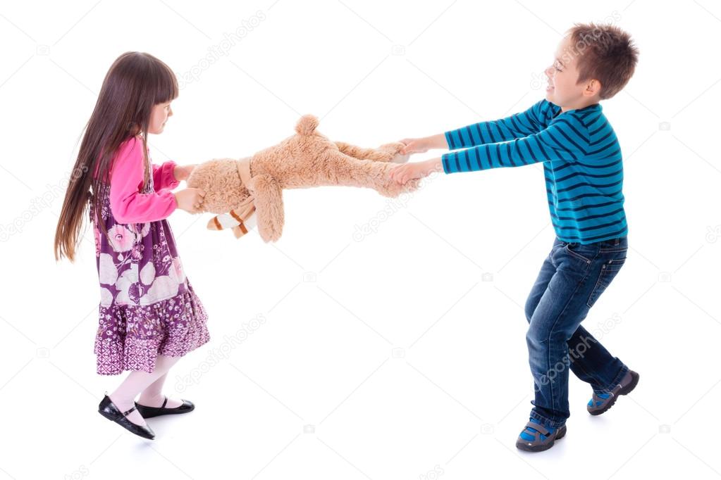 Boy and girl pulling toy bear