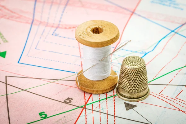 Sewing thread and thimble on pattern cutting