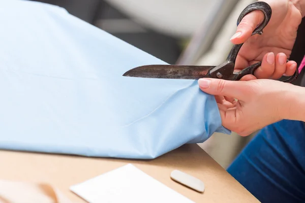 Cutting fabric with big old steel scissors — Stock Photo, Image