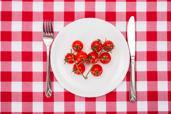 Cherry tomatoes launch on white plate — Stock Fotó