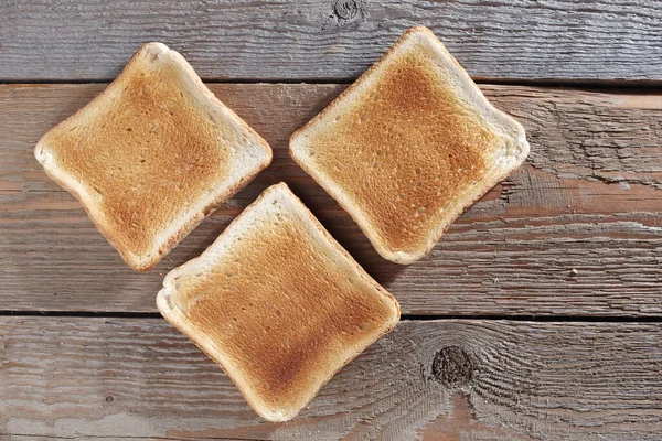 Tres Rebanadas Pan Tostado Sobre Fondo Madera Viejo Vista Superior —  Fotos de Stock