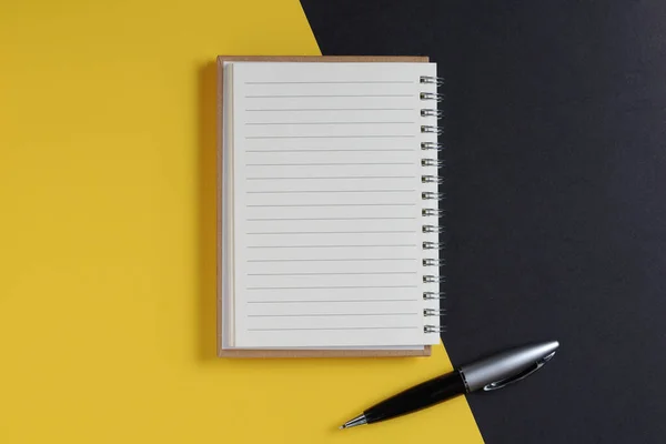 Notepad Pen Black Yellow Background Top View — Stock Photo, Image