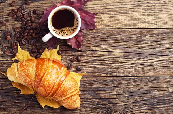 Kopje warme koffie en een croissant — Stockfoto