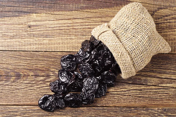 Dried plum in small sack — Stock Photo, Image