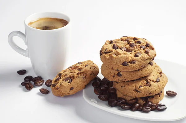 Cookies i plattan och kaffe kopp — Stockfoto