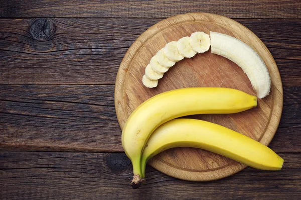 Ripe bananas and a sliced — Stock Photo, Image