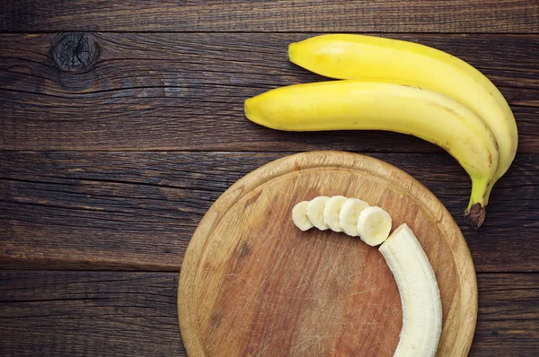 Bananas and a sliced — Stock Photo, Image