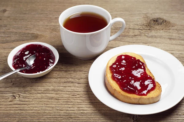 Witbrood met jam en thee beker — Stockfoto