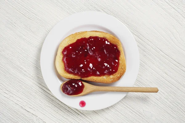 Bread with jam in plate — Stock Photo, Image