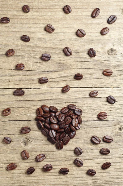 Grãos de café em forma de corações — Fotografia de Stock