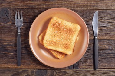 Toasted bread, fork and knife