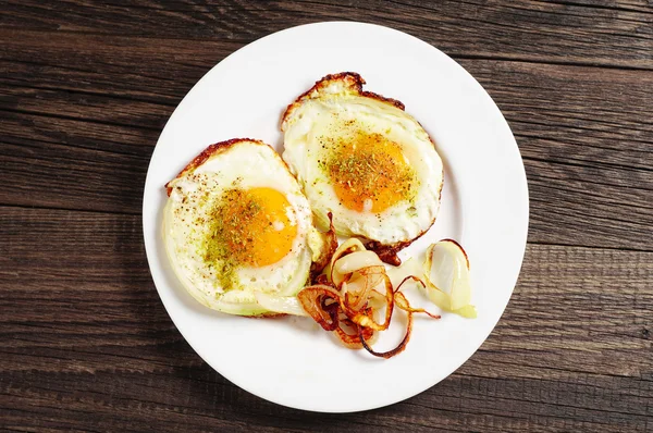 Fried eggs with onion — Stock Photo, Image