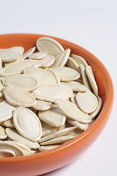 Pumpkin seeds in bowl — Stock Photo, Image