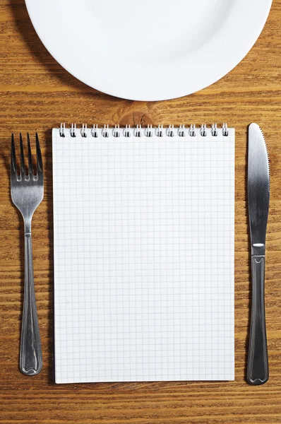 Notepad and cutlery — Stock Photo, Image