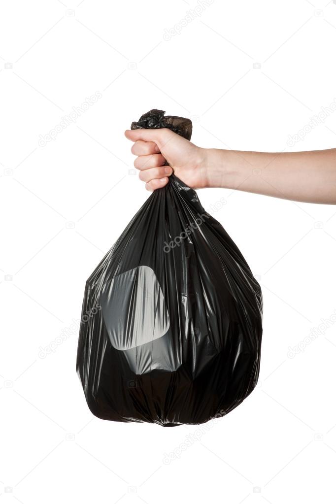 Hand holding trash bag