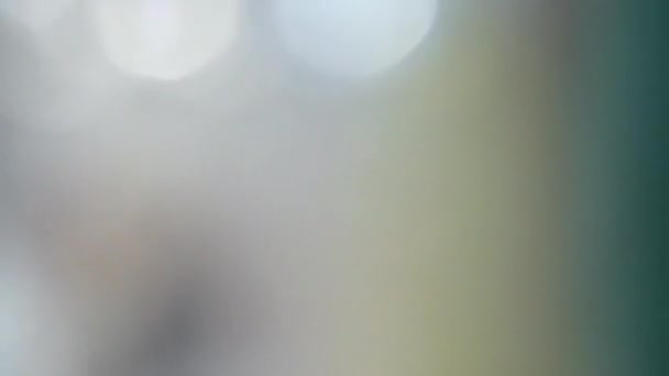 Lumières bokeh tombantes - animation abstraite hypnotique de lumières blanches et jaunes scintillant sur un fond coloré - 60fps - animation ralentissant et s'arrêtant .