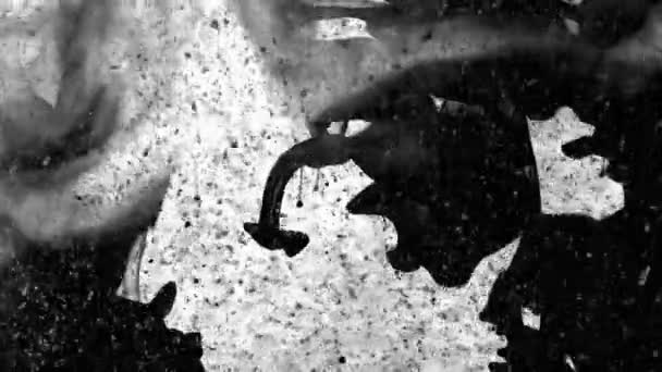 Black ink falling and creating volutes and dust particles moving on a white background - full hd — Stock Video