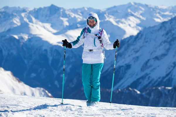 Beautiful girl goes for a drive on mountain skiing — Stock Photo, Image